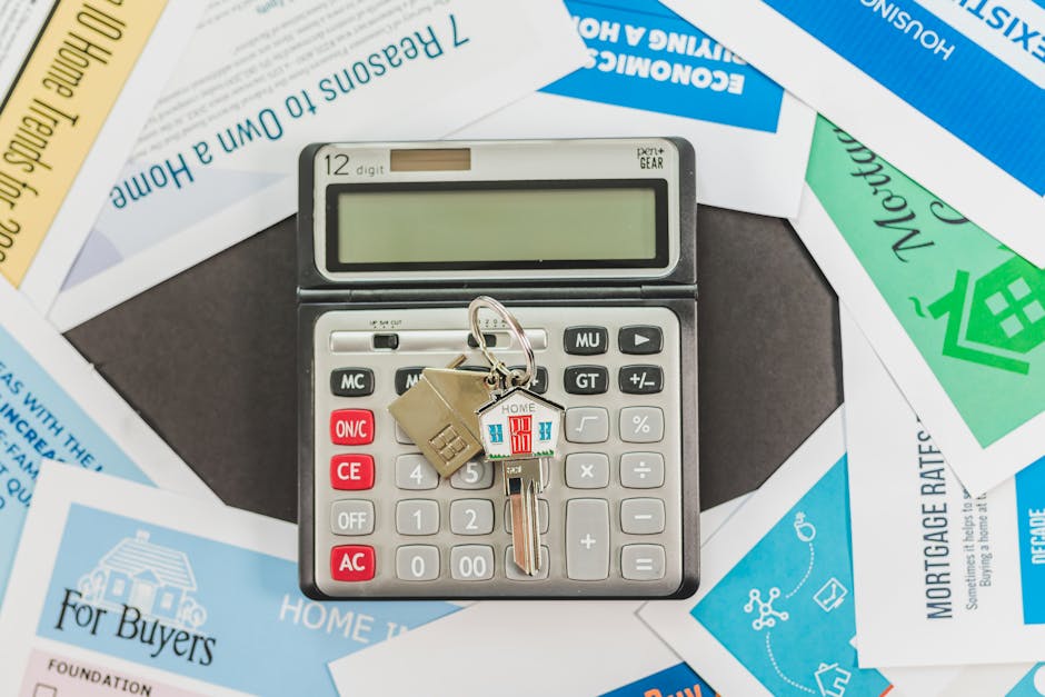 Calculator and house keys on a wooden table, symbolizing the start of a home equity journey